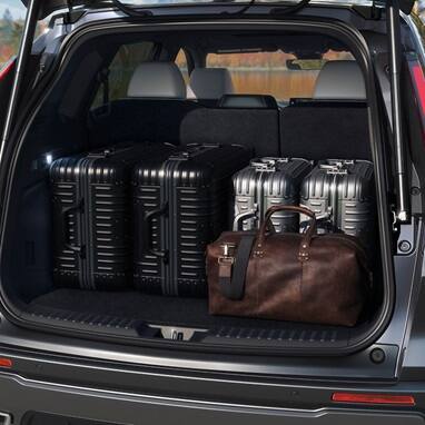  2027 Honda CR-V cargo area filled with suitcases and a leather duffel bag (Compact Crossover SUV).